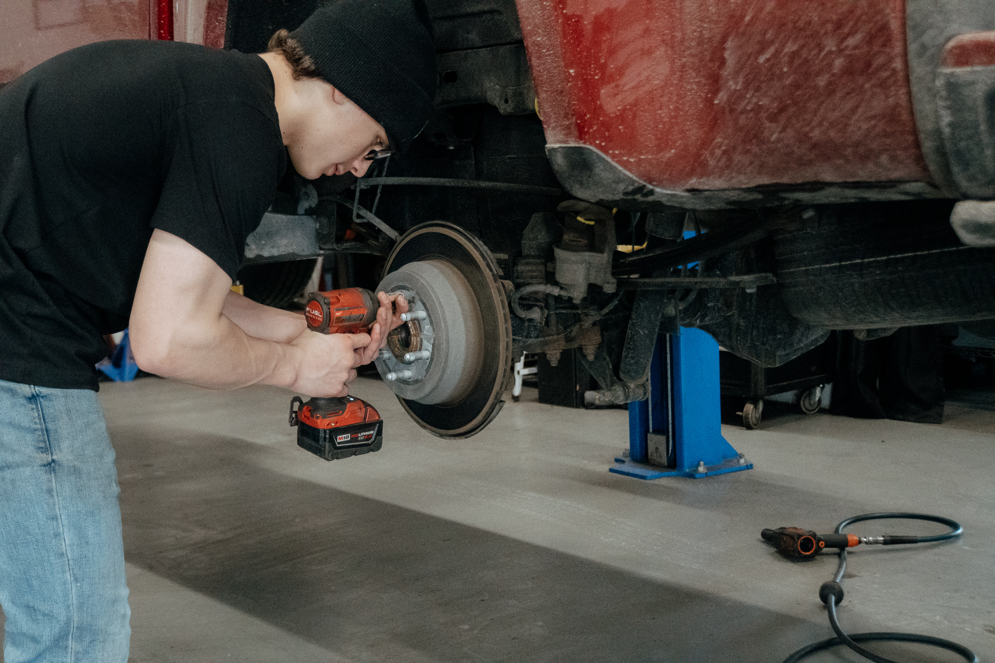 Student working on vehicle brakes