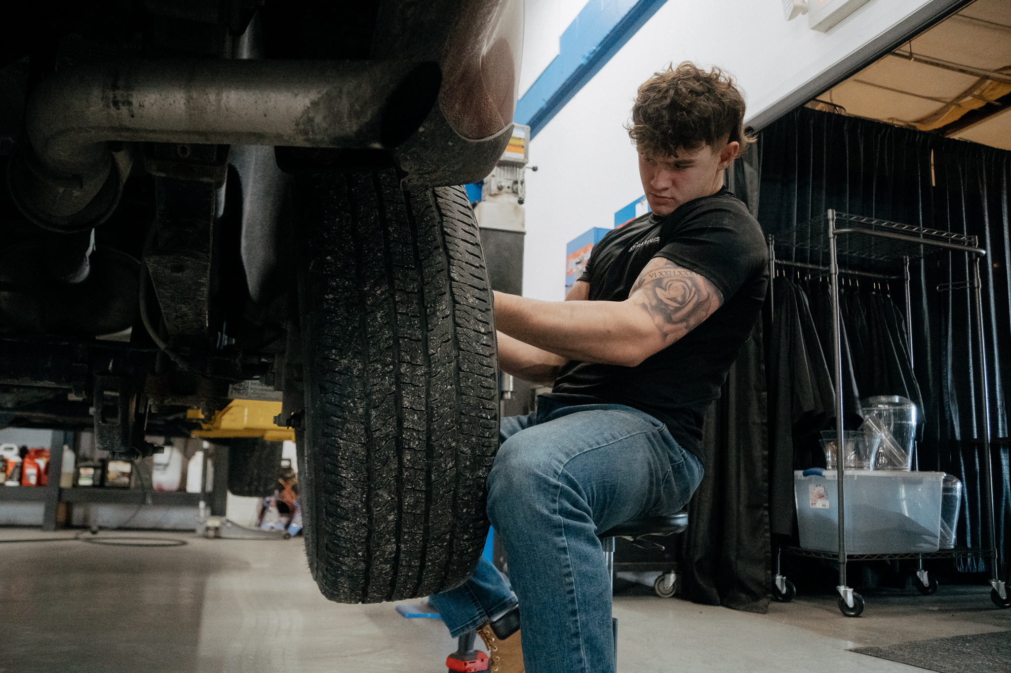 Student working on vehicle tire