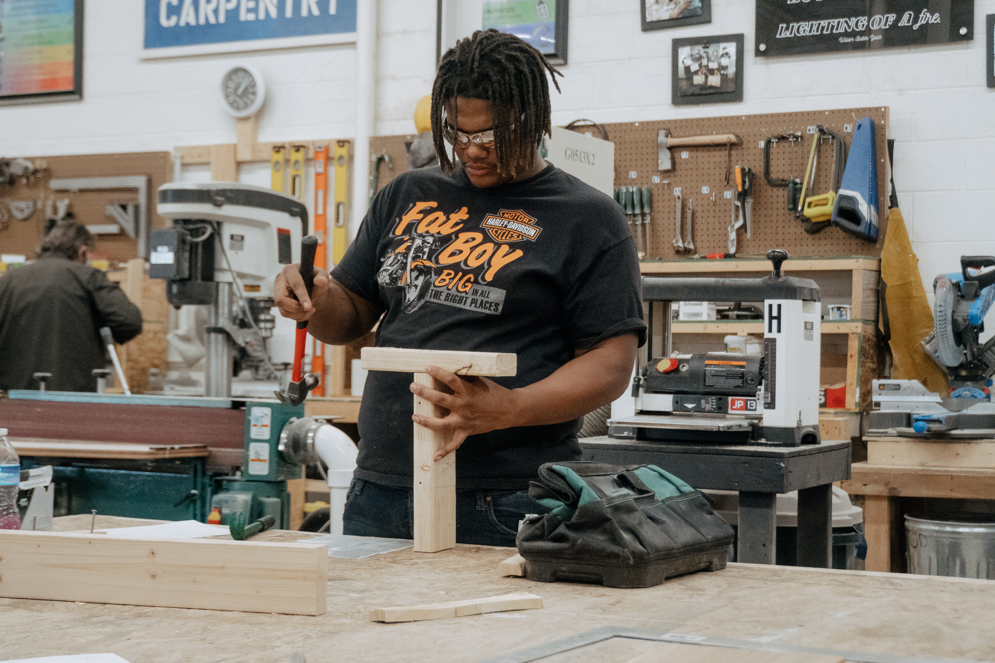 Student hammering in carpentry workshop