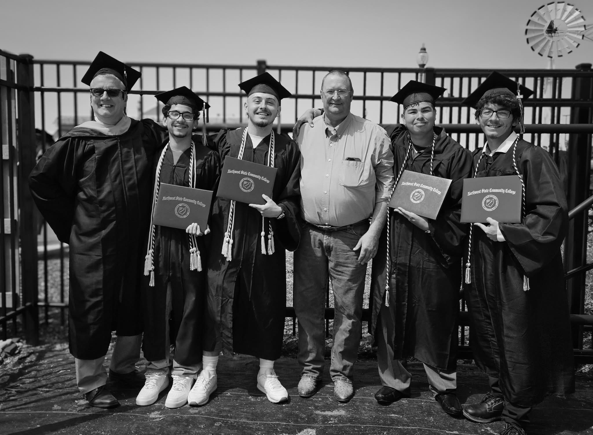 Students at graduation ceremony with diplomas