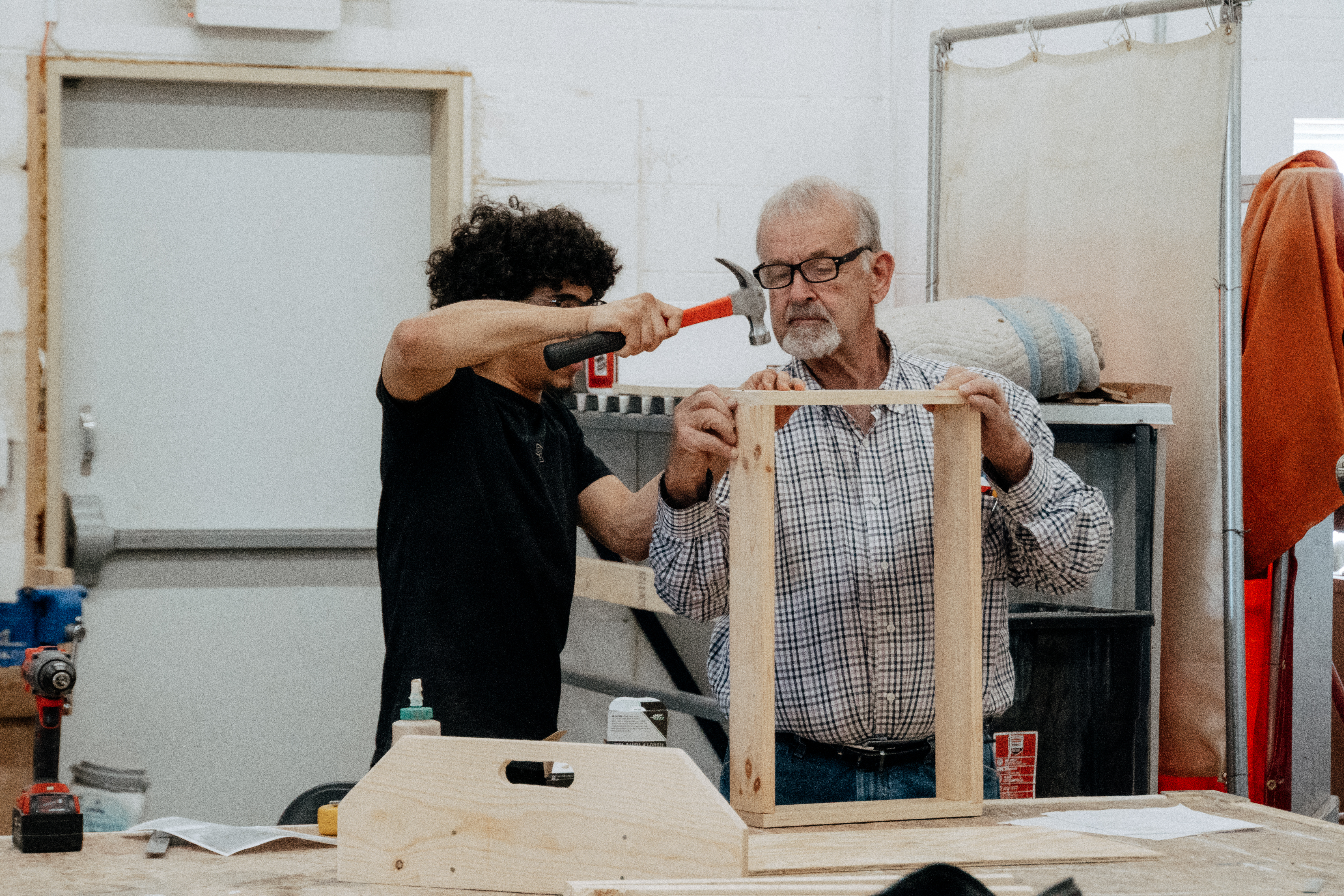 Mentor helping student with construction project